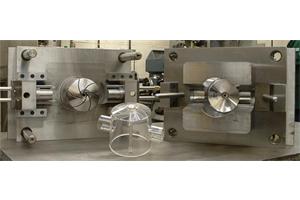 Injection mould tool with 2 side actions, insert loading and hot tip feed.