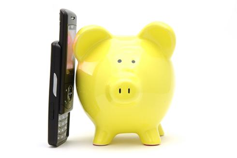 Yellow piggy bank talking on phone in isolated white background